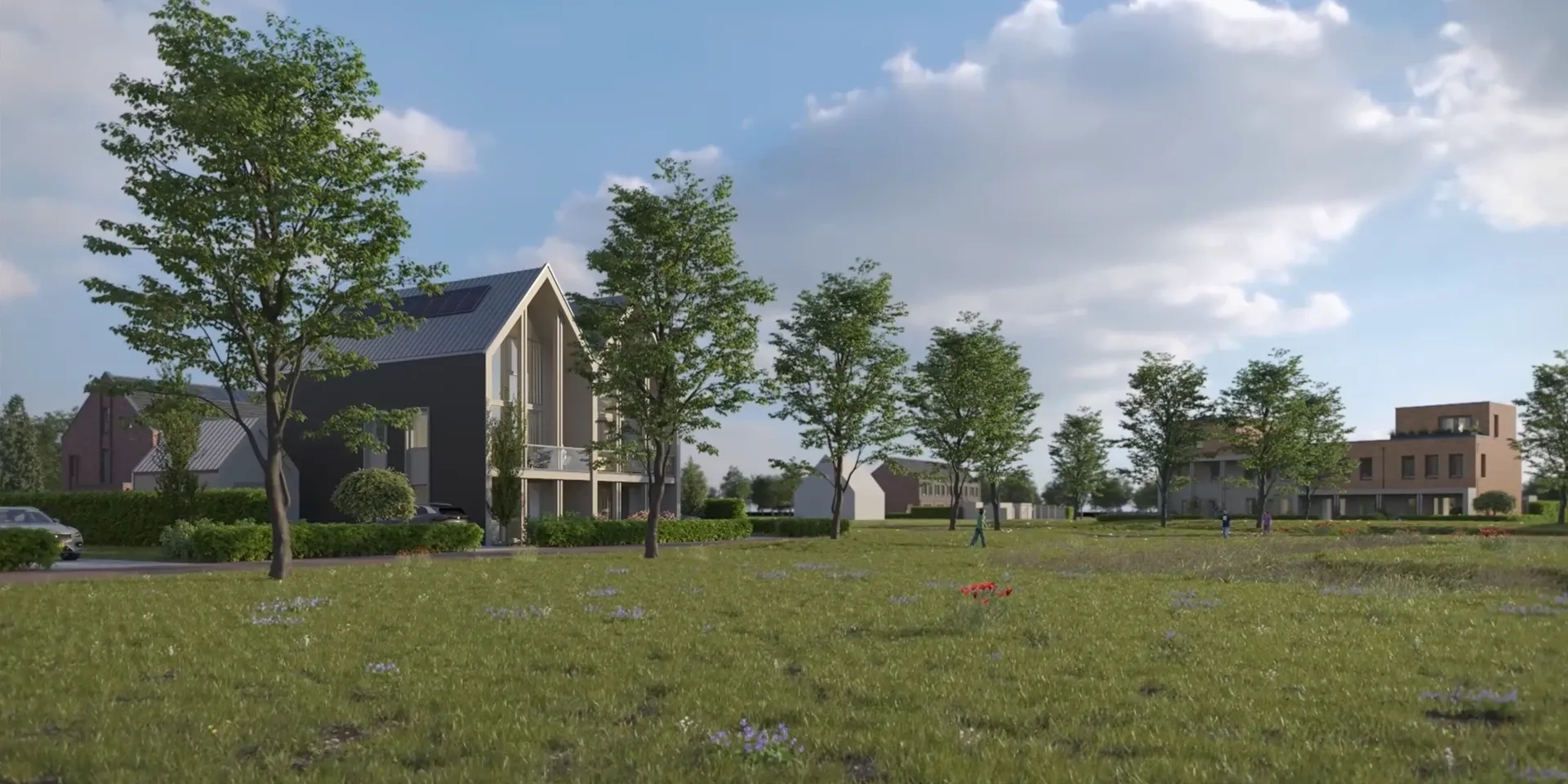 Nieuwbouwwoningen achter rij met bomen en grasveld