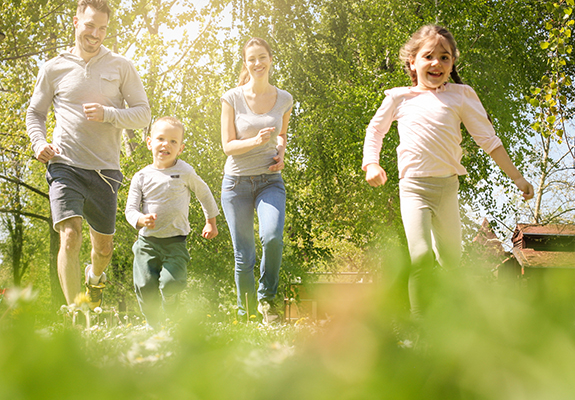 Cheerful family playing with their children's.